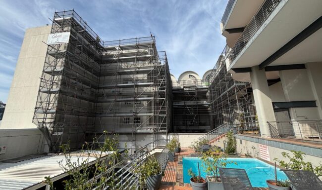 Exterior building repairs by Qabani National including plastering, painting and waterproofing.